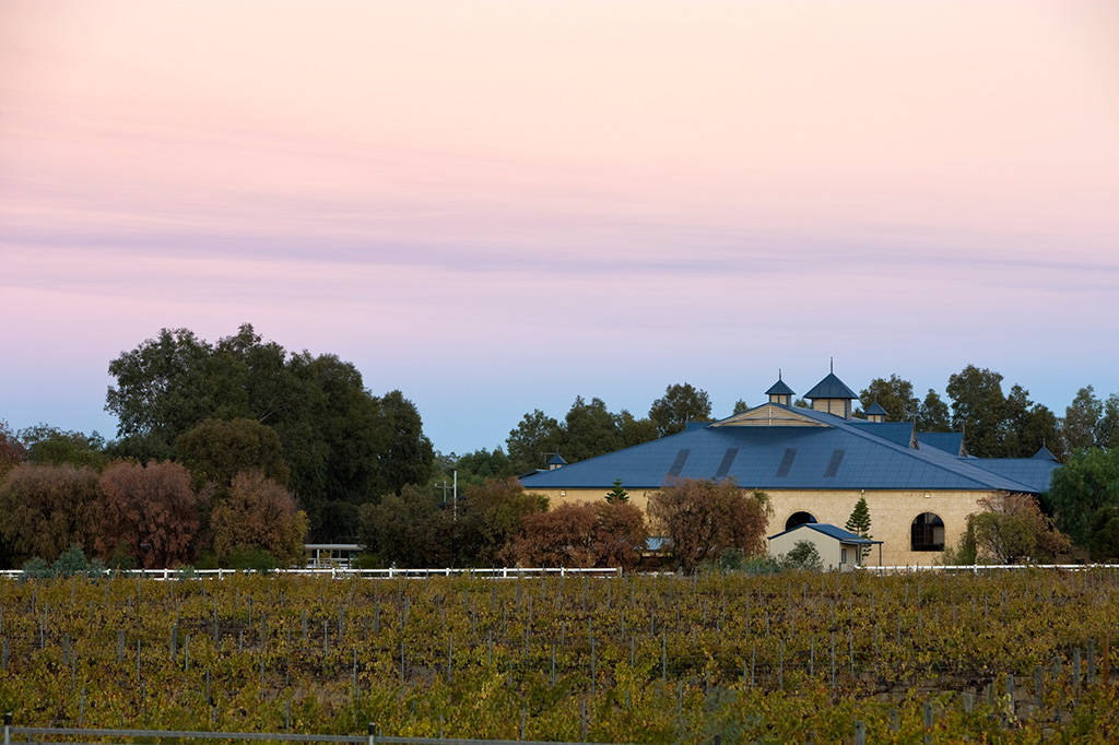 vineyards and limestone building